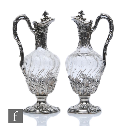 281 - A pair of late 19th Century French silver claret jugs, cushioned square bases with foliate details b... 