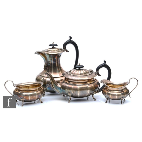 285 - A hallmarked silver four piece tea set of plain boat shaped panelled form, each raised on four scrol... 