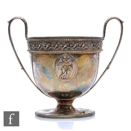 299 - A George III two handled pedestal cup, with beaded and scroll work band decoration above raised pane... 