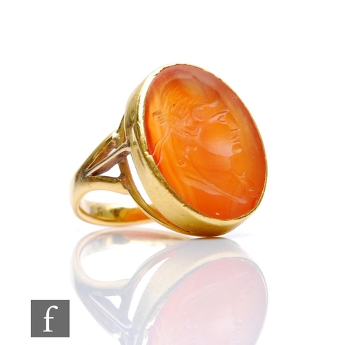 304 - A 19th Century 18ct intaglio carved carnelian ring, oval stone depicting profile of a classical woma... 