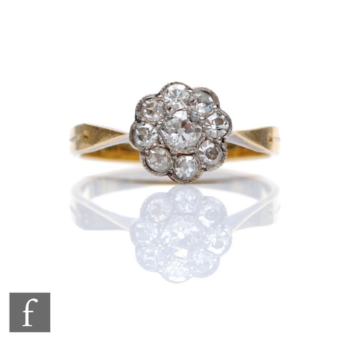 325 - An early 20th Century 18ct diamond daisy cluster ring, nine old cut stones to knife edged shoulders,... 