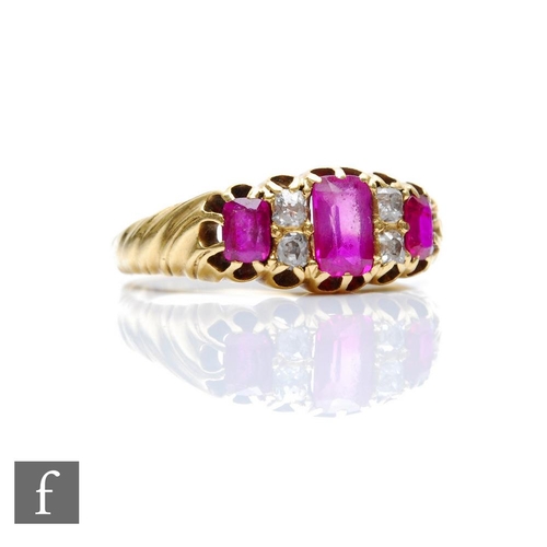 329 - An early 20th Century ruby and diamond seven stone boat shaped ring, three rubies spaced by diamonds... 