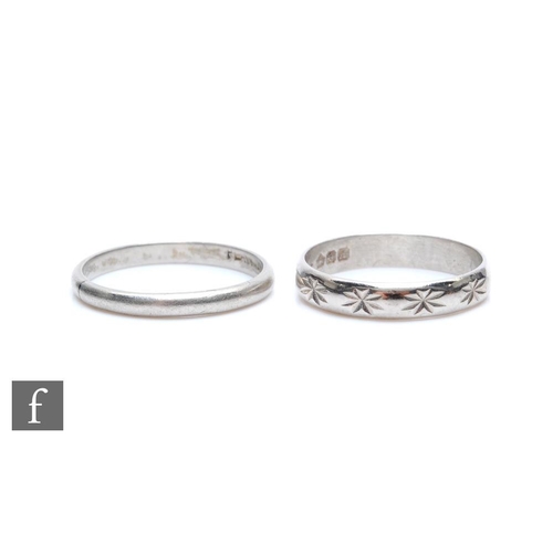 330 - Two platinum wedding rings, one plain the other patterned, total weight 7.7g. (2)