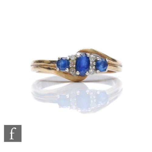 336 - A 9ct hallmarked sapphire and diamond seven stone ring, three sapphires spaced by diamonds all to a ... 