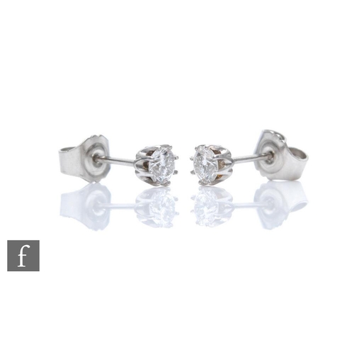 347 - A pair of 9ct white gold diamond solitaire stud earrings, brilliant cut stones each approximately 0.... 