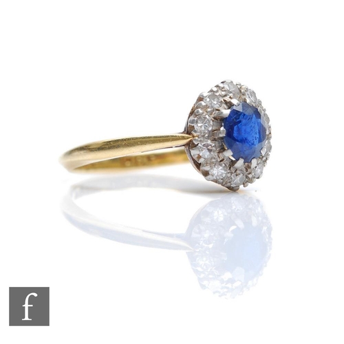 376 - An 18ct sapphire and diamond cluster ring, central oval sapphire within a diamond set border, weight... 