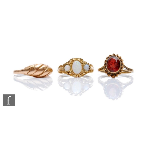 378 - Three 9ct rings to include a three stone opal and a single stone garnet example, total weight 7.5g, ... 