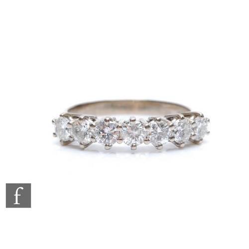 382 - An 18ct white gold diamond half eternity ring, seven brilliant cut claw set stones, total weight app... 