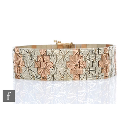 384 - A 9ct hallmarked bi coloured, matt finished brick bracelet with stylised star motifs, weight 51.2g, ... 