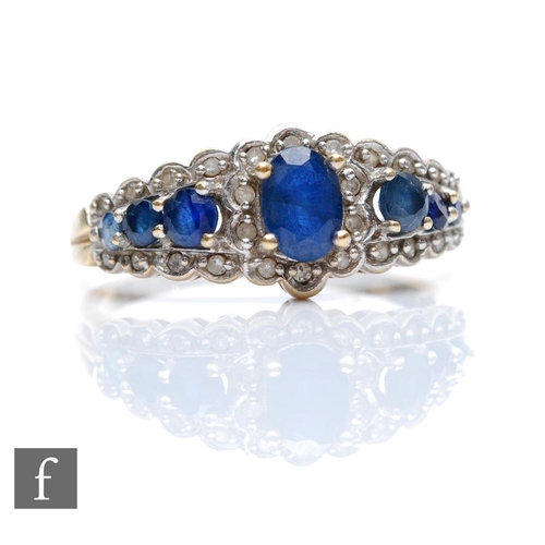 390 - A 9ct hallmarked Edwardian style sapphire and diamond ring, seven sapphires within a border of diamo... 