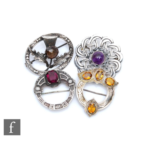 405 - Four 20th Century Scottish brooches, each set with a polished cabochon stone comprising two Sterling... 