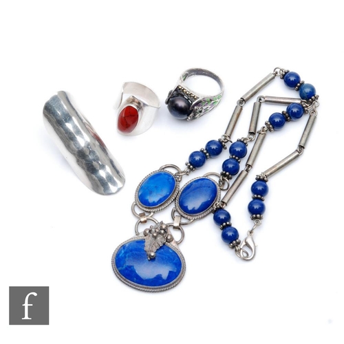 409 - Four pieces of later 20th Century costume jewellery comprising a white metal ring, a plique-a-jour r... 