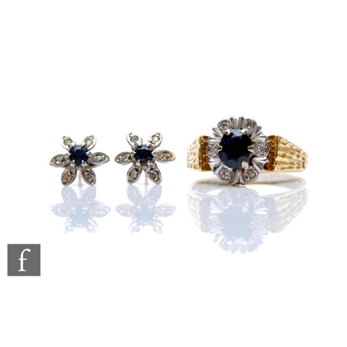 412 - A gold sapphire and diamond cluster dress ring and a pair of matching flower head ear studs. (3)