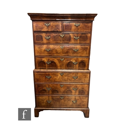 1053 - A George III walnut chest on chest, with moulded cornice pediment above an arrangement of eight draw... 