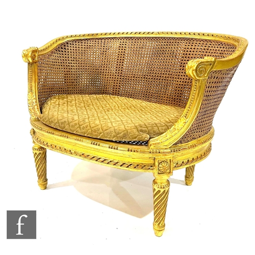 1057 - An early 20th Century Louis XVI style child's bergere salon sofa, with acanthus carved gilded frame ... 