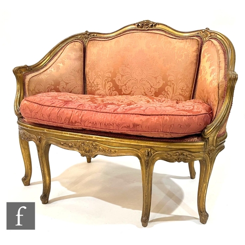 1058 - An early 20th Century two seat salon sofa in the Louis XVI style, with foliate detail to the exposed... 