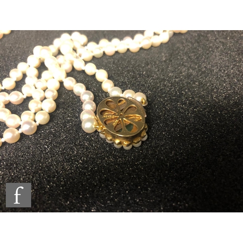 316 - A single row of uniform cultured pearls, length 156cm, each approximately 5mm diameter, terminating ... 