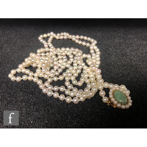 316 - A single row of uniform cultured pearls, length 156cm, each approximately 5mm diameter, terminating ... 