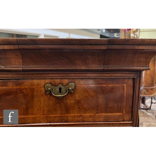 1053 - A George III walnut chest on chest, with moulded cornice pediment above an arrangement of eight draw... 