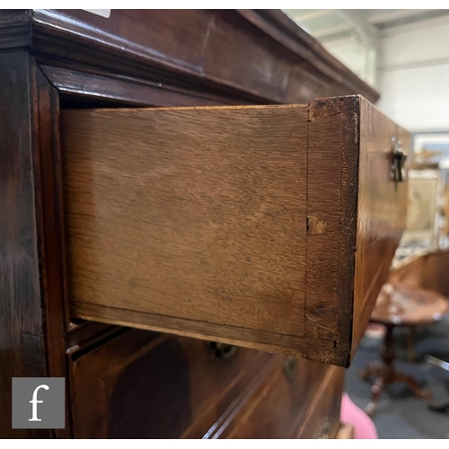 1053 - A George III walnut chest on chest, with moulded cornice pediment above an arrangement of eight draw... 