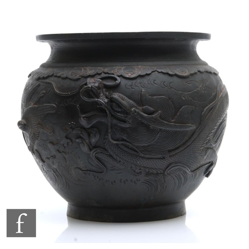 661 - A Japanese Meiji Period (1868-1912) bronze jardiniere, of rounded form, relief cast with birds and d... 