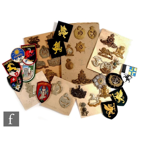 982 - A collection of military badges to include various regiments such as Royal Ulster rifles, Wiltshire,... 