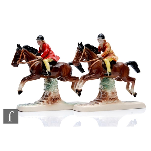 41 - Two Hertwig Katzhutte models of female horse riders dressed in red and yellow jumping a fence, both ... 