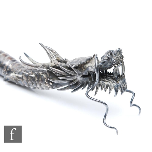 1180 - An early 20th Century white metal study of an articulated Japanese dragon with two claws to each foo... 