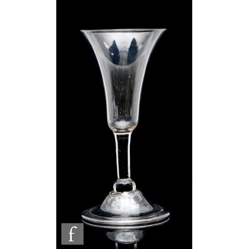 30 - An 18th Century balustroid drinking glass circa 1740, the slender flared trumpet bowl above a plain ... 