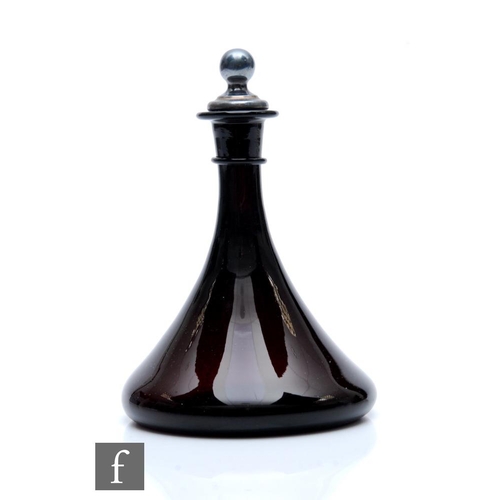 7 - A late 18th Century amethyst glass decanter, the wide base rising to a slender tapered neck with upp... 