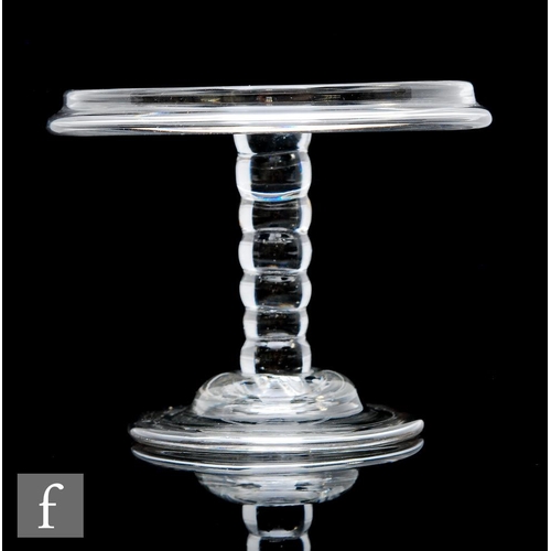 8 - An 18th Century glass patch stand circa 1740, the circular top with a vertical rim, raised to a six ... 