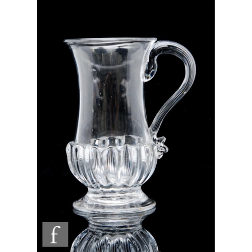 59 - An 18th Century glass tankard, circa 1750-1760, with gadrooned base and applied reeded handle, heigh... 