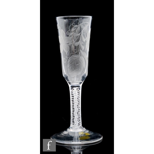 63 - An 18th Century ale glass circa 1760, the elongated ogee bowl engraved with hops and barley, above a... 