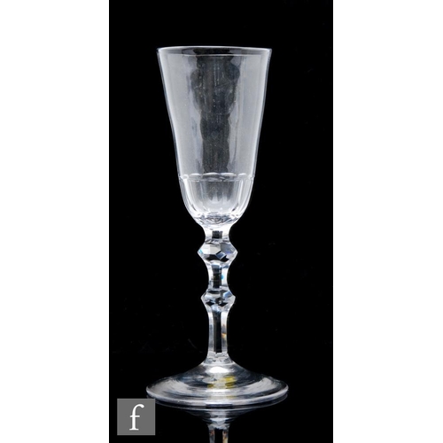 66 - An 18th Century ale glass, circa 1780, the elongated round funnel bowl with basal petal moulded flut... 