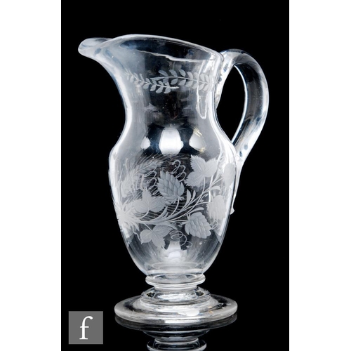 72 - An 18th Century etched lead glass ale jug, circa 1780, of footed baluster form, engraved with the na... 