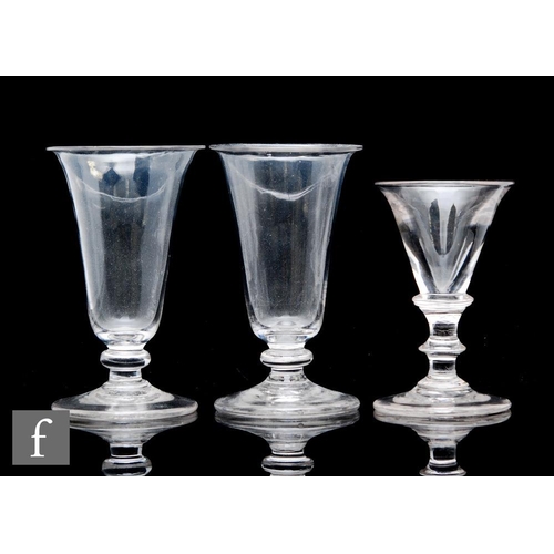 92 - A pair of late 18th Century jelly glasses, each with folded everted funnel bowl above stem with flat... 