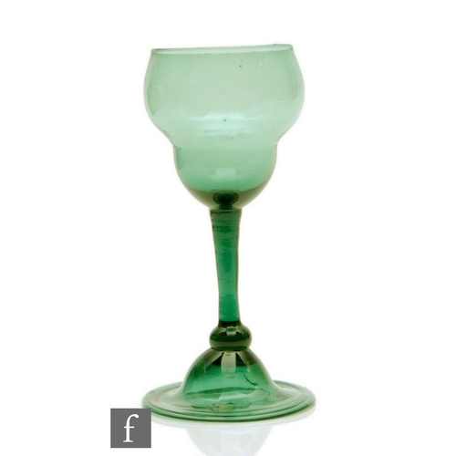 2 - An 18th Century Bristol green drinking glass circa 1755, the swollen ogee form bowl above a slender ... 