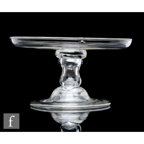 296 - An 18th Century clear crystal patch stand, circa 1750, with a circular top and everted rim above a h... 