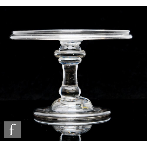 297 - An 18th Century clear crystal glass tazza, circa 1740 with a wide circular top and collar rim, above... 