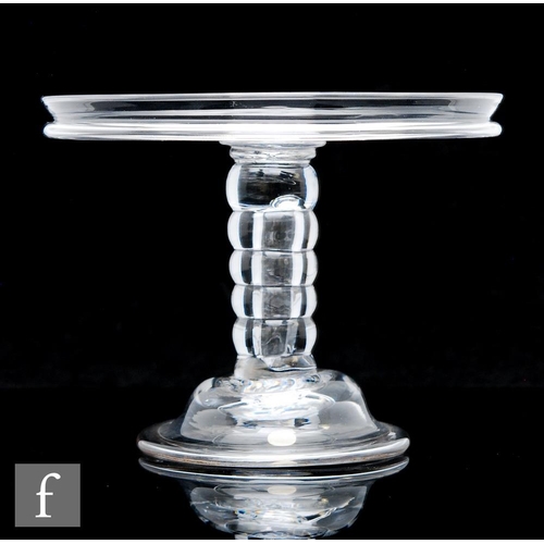 298 - An 18th Century clear crystal glass tazza circa 1740, with a wide circular top and collar rim, above... 