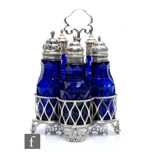 320 - An 18th Century hallmarked silver condiment stand with five bottles, the Bristol blue bottles facet ... 