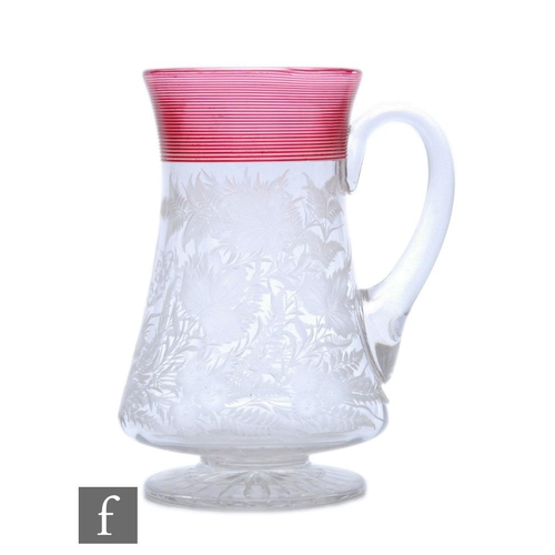 483 - A large 19th Century Stourbridge glass tankard, circa 1870, of waisted footed form with loop handle,... 