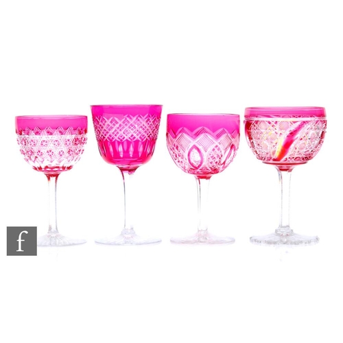 498 - A mixed collection of four late 19th Century Stourbridge wine glasses, each cased in ruby over clear... 