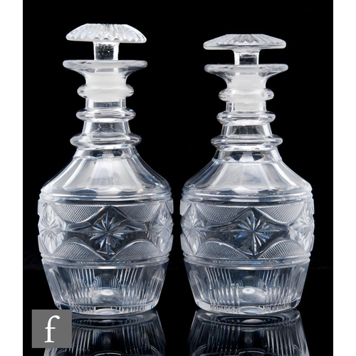 311 - A pair of Irish clear crystal Waterford style decanters, circa 1810, of Prussian form, with star and... 