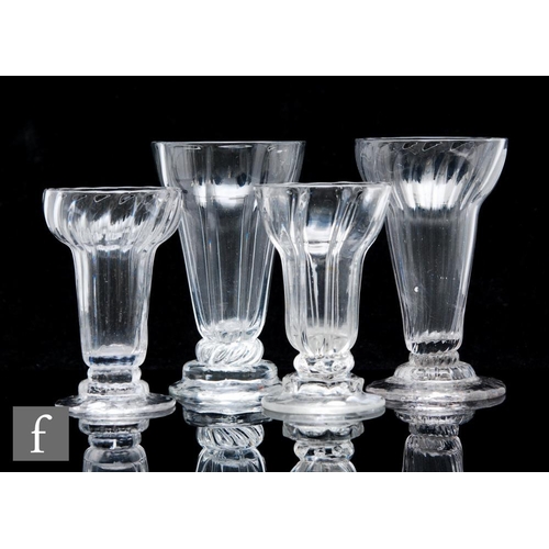 234 - A collection of four assorted 18th Century pan top syllabub glasses circa 1770, each rib moulded and... 