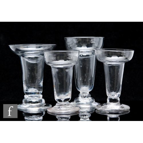 238 - A collection of four assorted pan top syllabub glasses, circa 1770, each with plain body, two with b... 