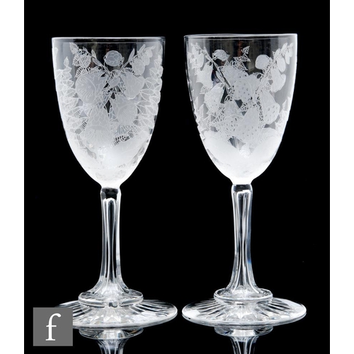 484 - A pair of late 19th Century Stourbridge, clear crystal goblets, the round funnel bowls decorated wit... 