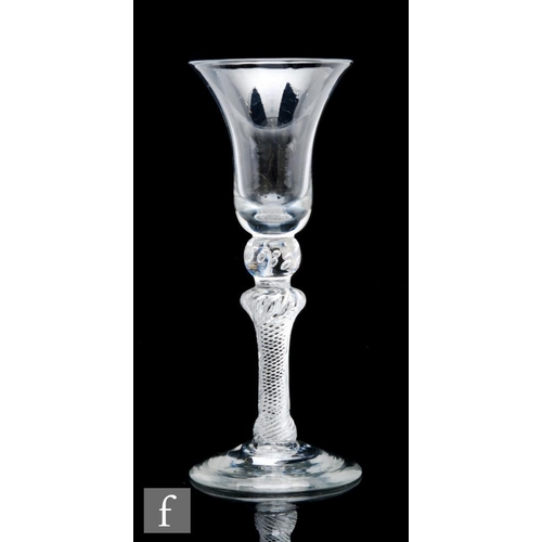 103 - An 18th Century composite stem drinking glass circa 1750, the bell bowl above a beaded knop, short s... 