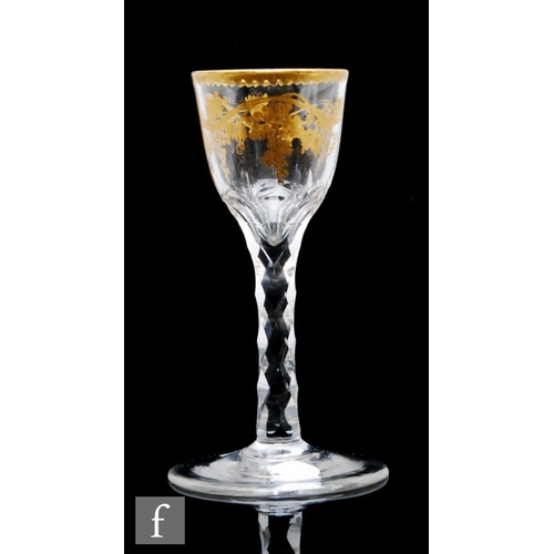 168 - An 18th Century drinking glass circa 1775, the ogee form bowl gilded in the manner of James Giles, w... 