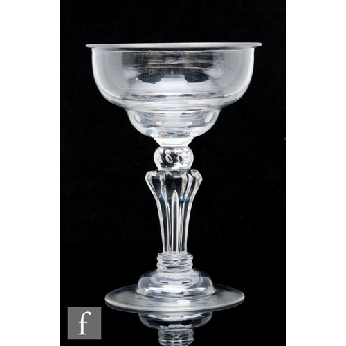 114 - An 18th Century sweetmeat glass circa 1740, the ogee bowl with folded rim, above a stem with collar ... 